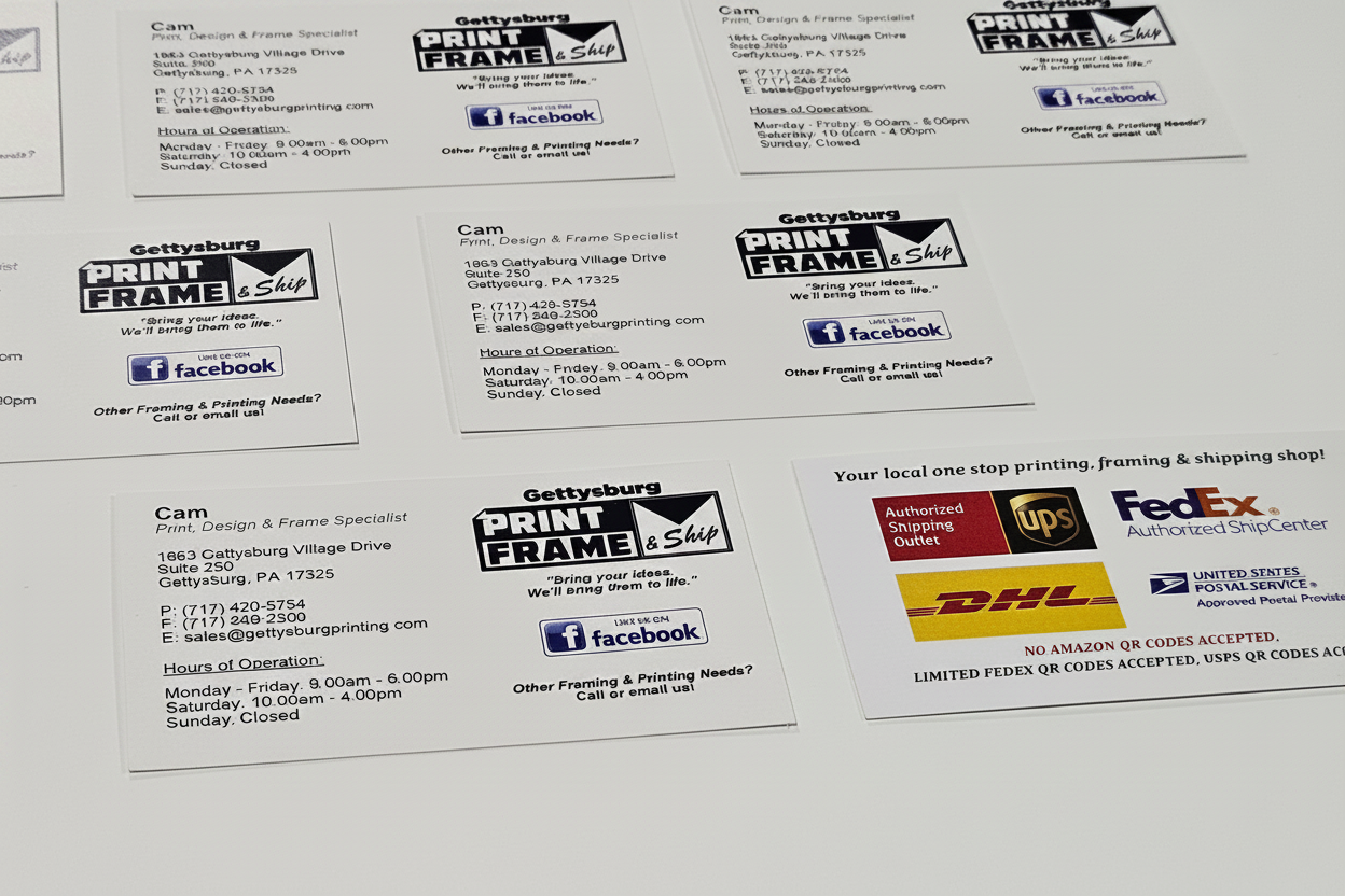 Business cards flat lay showing multiple printed cards on white surface