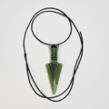 Green resin arrowhead pendant necklace on white background